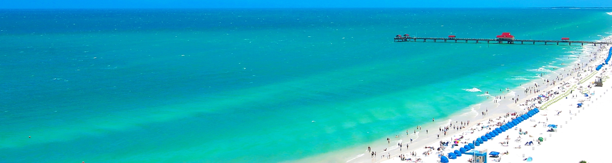 Image of beach with umbrellas and people